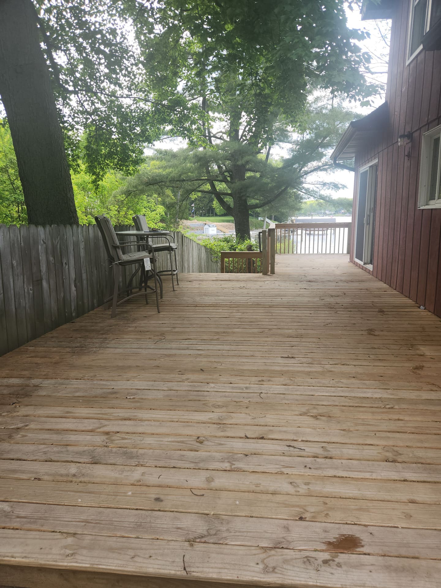 Lower patio with Adirondack chairs at the water’s edge