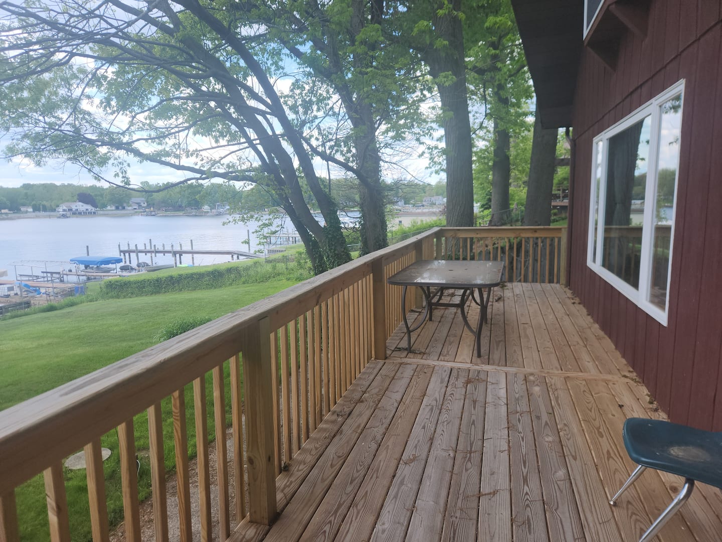 Large grassy backyard leading down to Spring Lake
