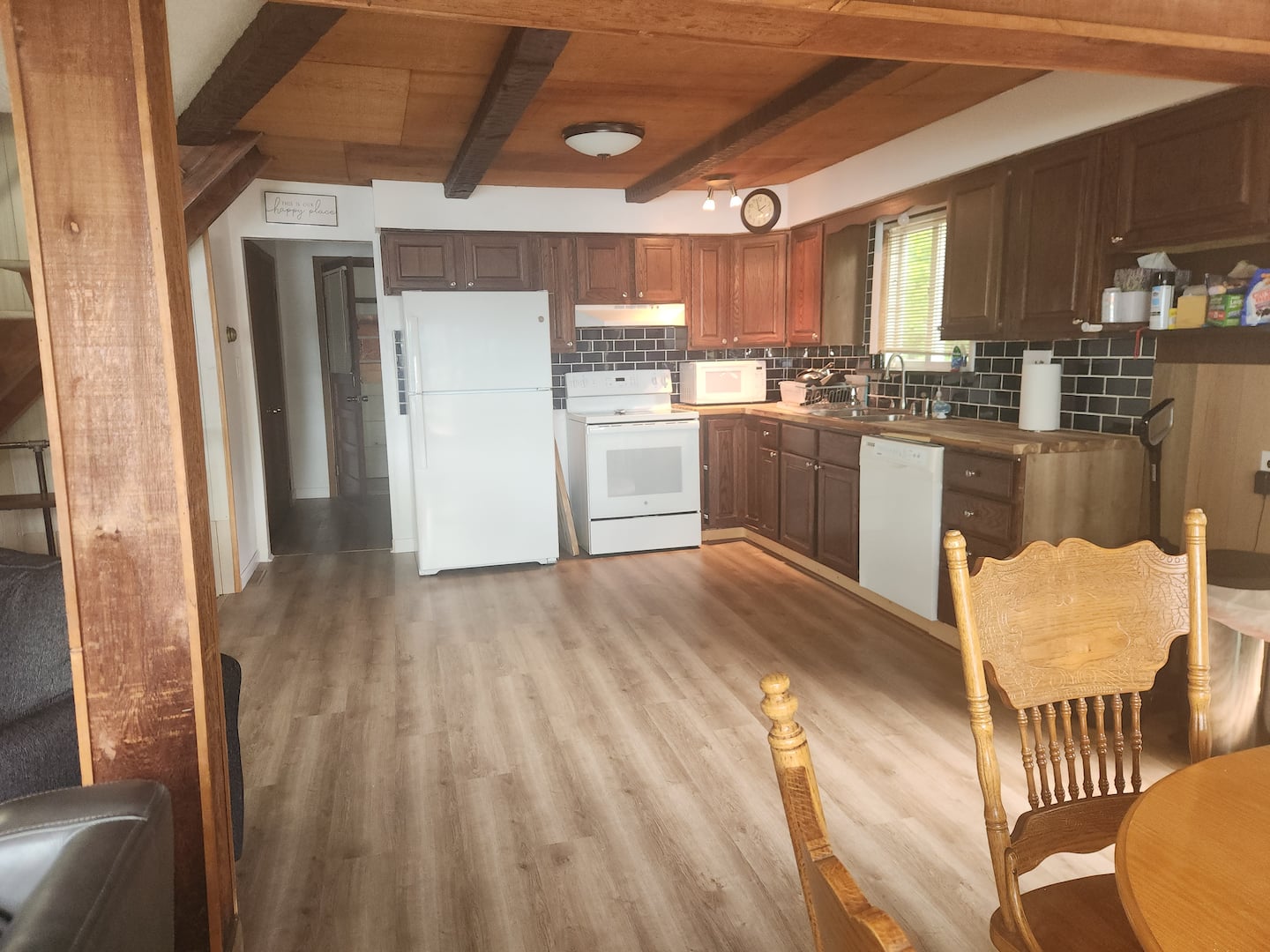 Full kitchen with wood cabinets, range, and breakfast seating